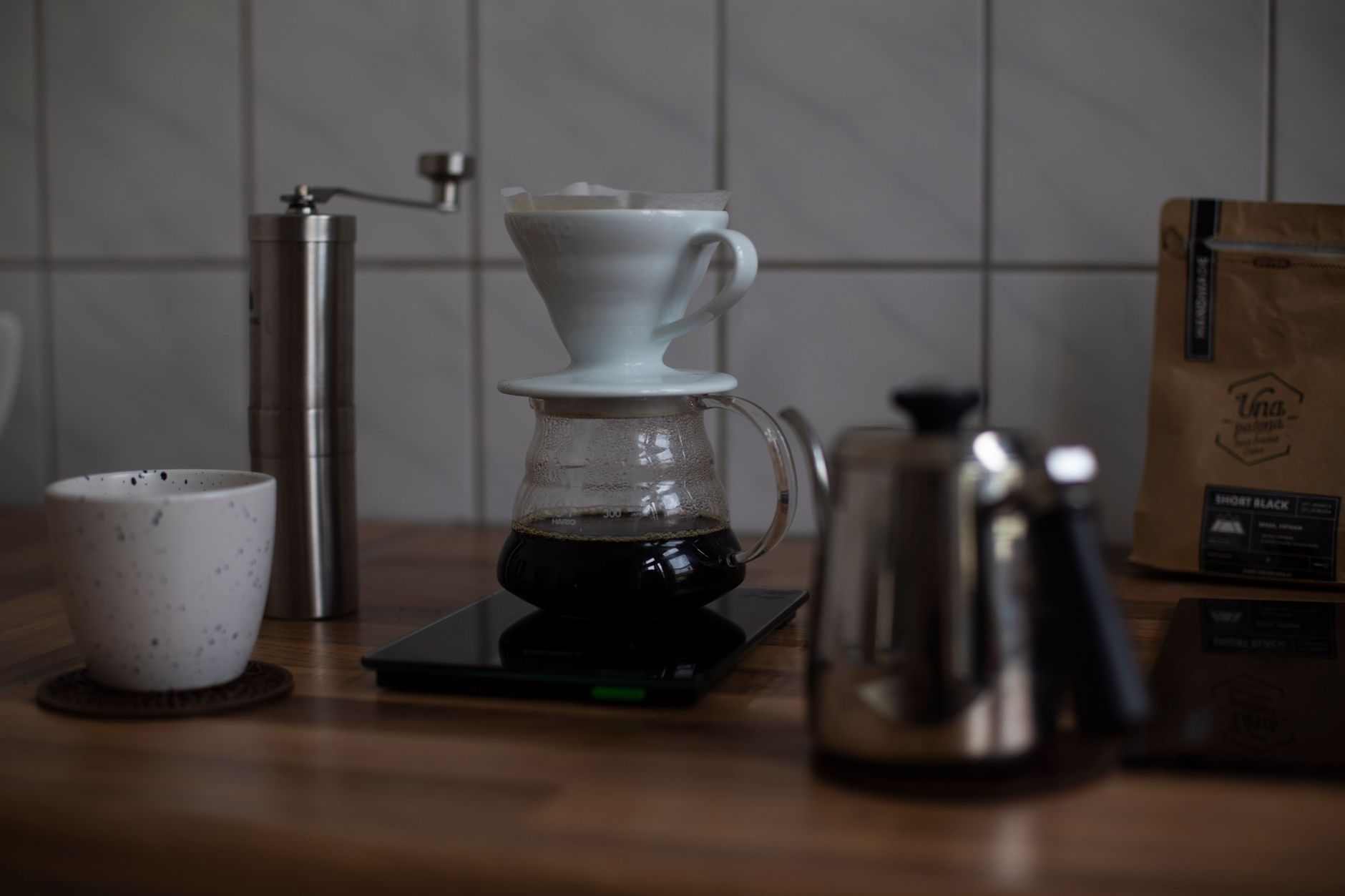Pour-over dripper sitting on a digital coffee scale mid-brew